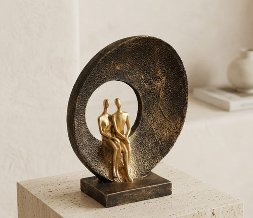 Gold Embrace in Gold couple sculpture by House of Mandana, featuring a circular centerpiece with intertwined figurines.